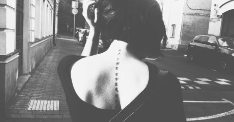 Rear View Of Woman Walking In Street